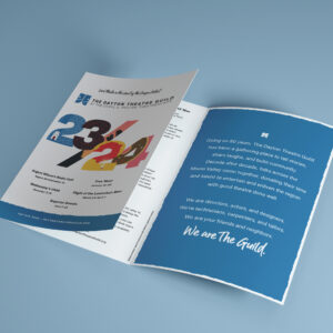 Open booklet showing a page of text and a cover page with a colorful "23-24" graphic, promoting The Dayton Theatre Guild's current season, including show titles and a mission statement.