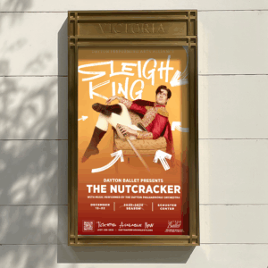 A poster for Dayton Ballet's "The Nutcracker" features a performer lounging on a sleigh, with event dates, ticket info, and venue details displayed below.