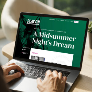 Person using a laptop displaying a website for "A Midsummer Night's Dream" by Shakespeare with a green background and a partial image of a donkey.