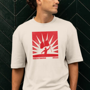 A person wearing an off-white t-shirt featuring a red graphic of a silhouetted figure holding a flag with the text “HUDSON VALLEY SHAKESPEARE 2026 Season.”